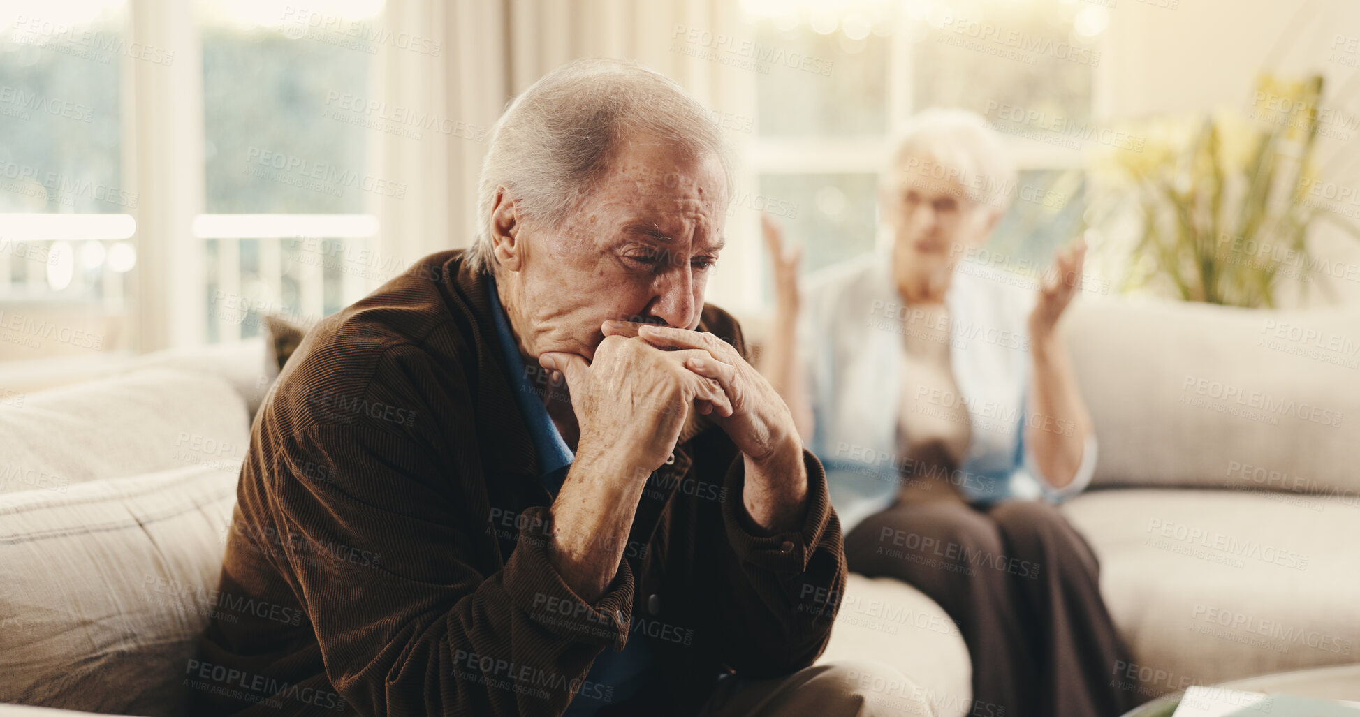 Buy stock photo Fighting, upset and senior man on sofa in home with argument, disagreement or divorce on weekend. Stress, couple and elderly person in living room with marriage fail, breakup or conflict in house.