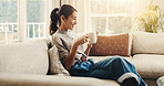 Smile, woman and relax at house with phone, social media and browsing online for latest movies. Happy, female person and coffee in lounge with mobile, internet search and streaming for film watchlist