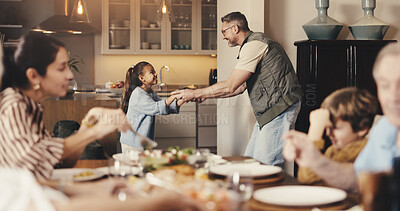 Buy stock photo Big family, dinner and dad with girl for dance, bonding and playful together in home. Holding hands, smile and father with daughter for fun and support with love, music and help with development
