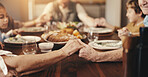 Holding hands, prayer and family at dinner in home, gratitude for meal and faith with bonding. People, together and thanks to God for food on table, relationship and religion with gathering at house