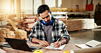 Man, writing and clipboard at workshop for carpentry, stock and timber price for production. Carpenter, laptop and checklist at factory for compliance, quotation and order for manufacturing furniture