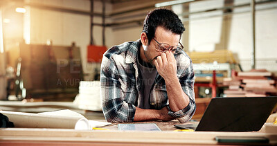 Buy stock photo Man, carpenter and glasses with eye strain in warehouse for wood production fail or freight delay. Frustrated, male person or carpentry mistake with stress or laptop for bad news on delivery schedule