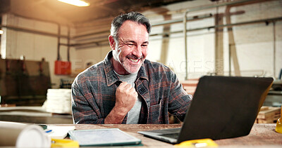Buy stock photo Mature, carpenter and happy man with success on laptop for good news or in business workshop. Excited, male person or carpentry with smile, computer or fist pump for achievement in wood warehouse
