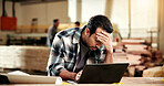 Man, carpenter and laptop with stress in workshop for wood production deadline or freight delay. Frustrated, male person or carpentry mistake with computer for bad news, pressure or timber project