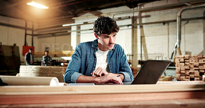 Buy stock photo Carpenter, reading and man with laptop in workshop, online or searching for furniture design on web. Manufacturing, factory and person with technology, research and planning for woodworking project