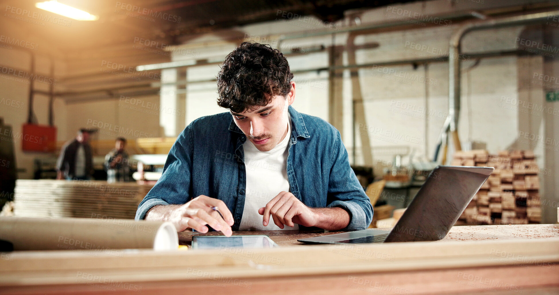 Buy stock photo Carpentry, man and tablet review in workshop for planning custom project, joinery sizing or CAD. Serious, carpenter and tech in warehouse for furniture production, inventory update and material specs