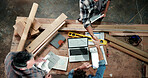 Carpenter, handshake and above of men on laptop for planning, production deal and agreement. Construction, team and people on computer for review, partnership and woodworking for timber business