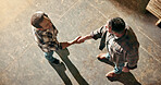 Man, carpenter or meeting with handshake for woodwork, timber distribution or lumber trading deal. Top view, male people or employee shaking hands with agreement for carpentry business or partnership