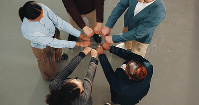 Buy stock photo Business, people and meeting with fist bump for collaboration, unity or team solidarity. Top view, diversity or group of employees with hands together in huddle for cohesion, inclusion or mission