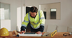 Construction, tablet and man with blueprint, planning and drawing for building design in office. Architecture, contractor and person at desk with tech, sketch and remodeling layout for renovation