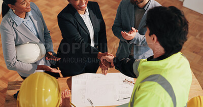 Buy stock photo Architect, investor and shaking hands at site for agreement, renovation deal or applause. People, blueprint or handshake on worksite for funding contract, contractor offer or thank you with clapping
