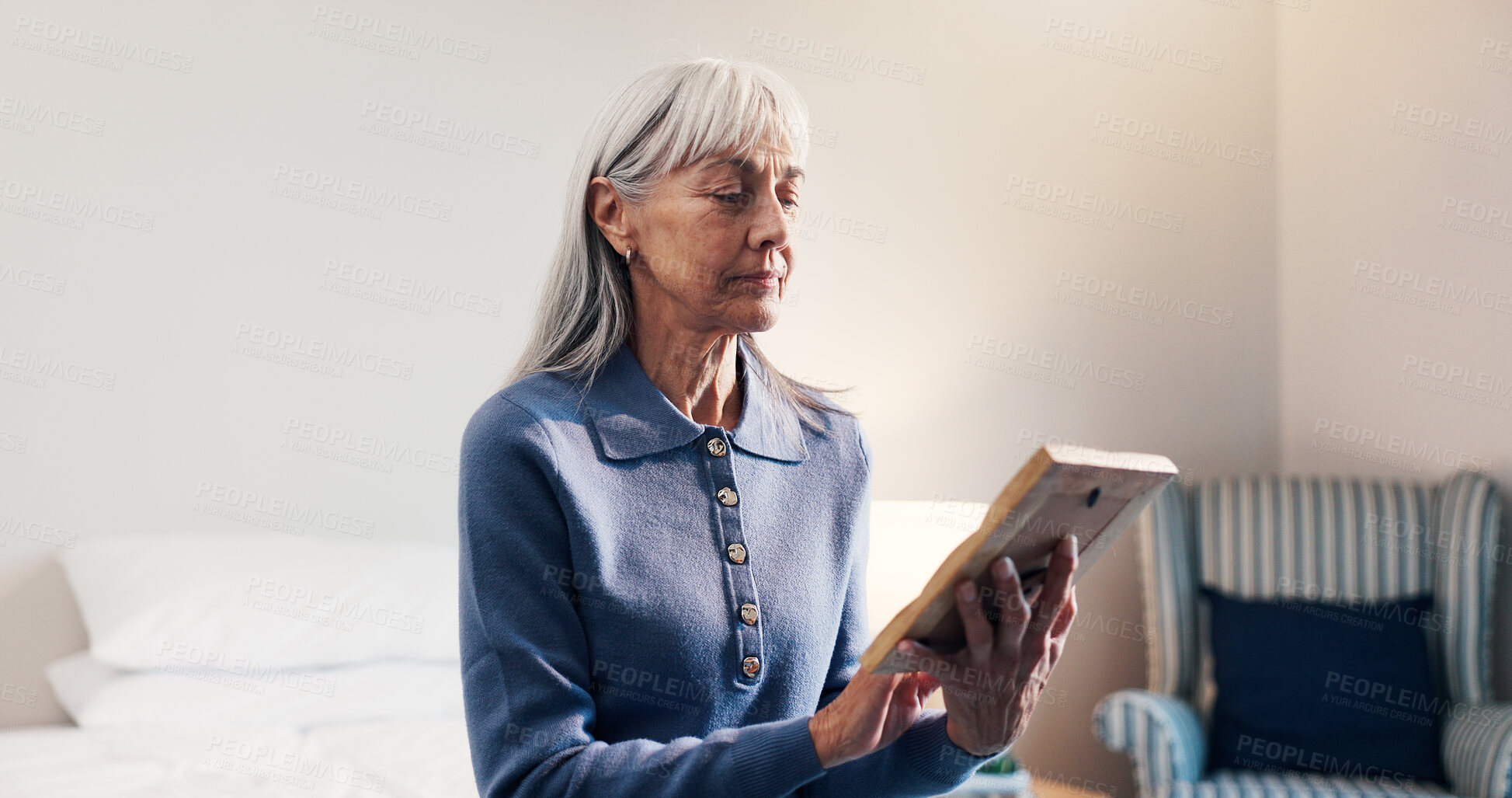 Buy stock photo Thinking, photo frame elderly woman in home with memories, nostalgia and lonely in retirement. Senior widow, reflection and picture in bedroom for reminder, broken heart and looking at souvenir