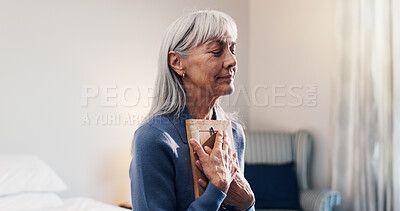 Buy stock photo Reflection photo frame senior woman in home with memories, nostalgia and lonely in retirement. Elderly widow, reminisce and picture in bedroom for reminder, broken heart and hug with souvenir