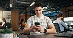 Man, typing and reading in office with phone, software engineer website or search trends for project. Bokeh, coworking and person in digital agency with tech, IT news article or text message for work