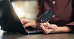 Woman, hands and laptop with credit card in office for online shopping, purchase or banking. Female person, employee or shopper with debit, computer or lens flare for ecommerce or wireless payment