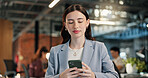 Woman, typing and email in office with phone, internet network and digital communication for company. Bokeh, coworking and person in agency with tech, text message and mobile app for business chat.