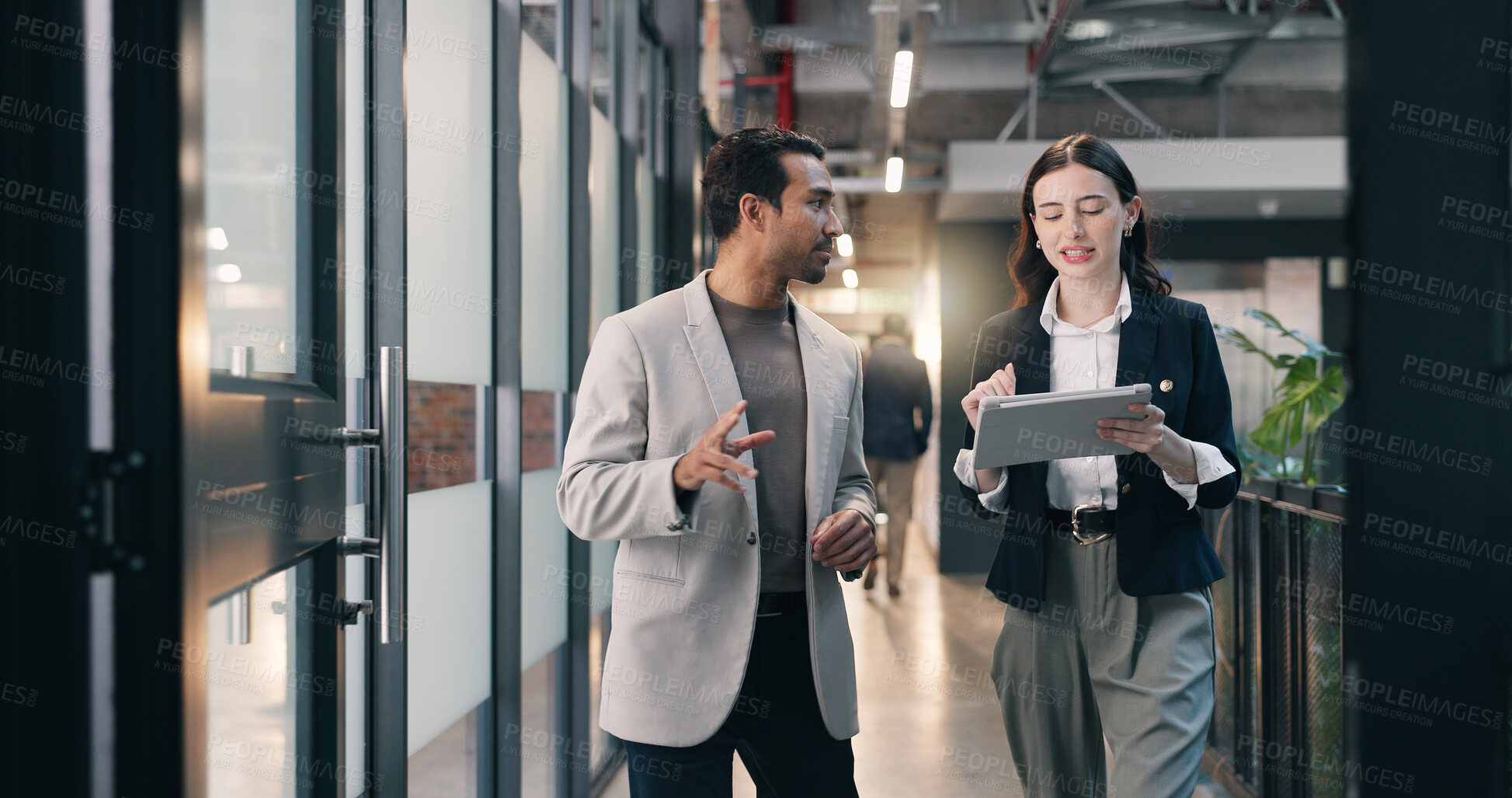 Buy stock photo Walking, hallway and business people on tablet for talking, meeting and update for finance review. Office, team and man with woman on tech for online report, financial proposal or planning for budget