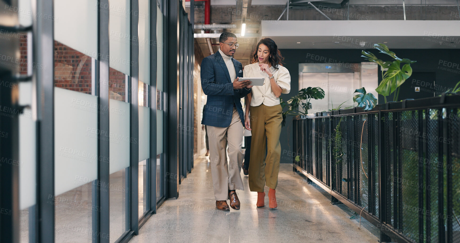 Buy stock photo Walking, hallway and business people on tablet for meeting, discussion and update for finance review. Office, team and man with woman on tech for online report, financial proposal and budget planning