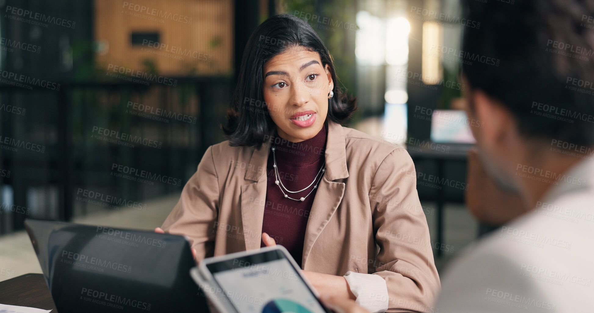 Buy stock photo Woman, business or meeting with discussion in office for performance review, statistics or data. Female person, employee or talking with colleague, laptop or tablet for project conversation or report