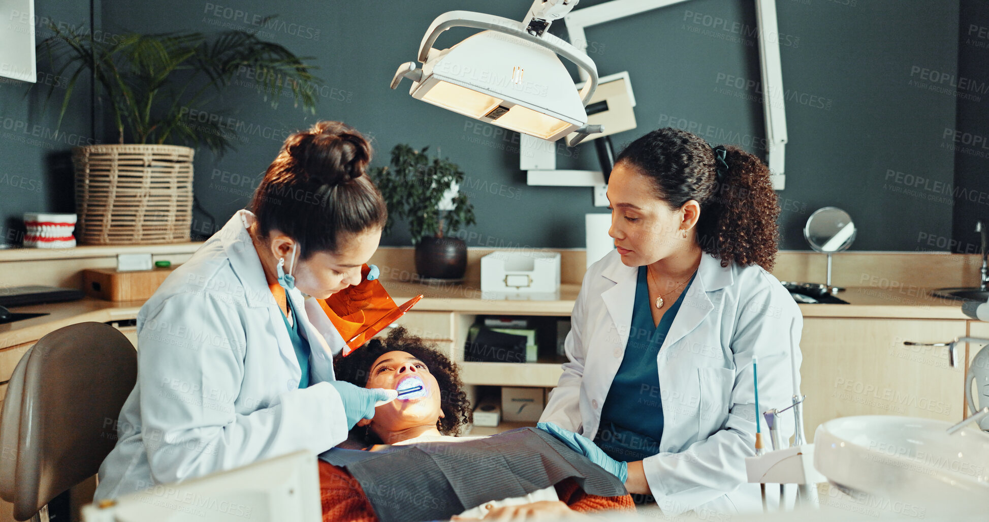 Buy stock photo Dentist, operation and teamwork in office with patient for dental surgery or tooth extraction. Assistance, healthcare and procedure with people in dentistry practice for checkup or oral care