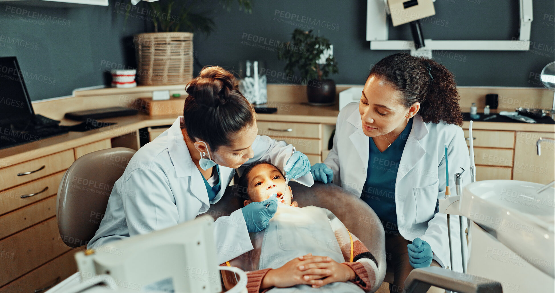 Buy stock photo Assistant, tools and dentist with child in clinic for teeth cleaning, assessment or checkup. Oral hygiene, consultation and orthodontic team with girl kid for tooth extraction for dental health.
