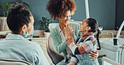 Buy stock photo Mom, dentist and girl with high five in clinic for dental success, oral hygiene or treatment. Mother, orthodontist and child with smile, support or good news for teeth checkup, winning or results