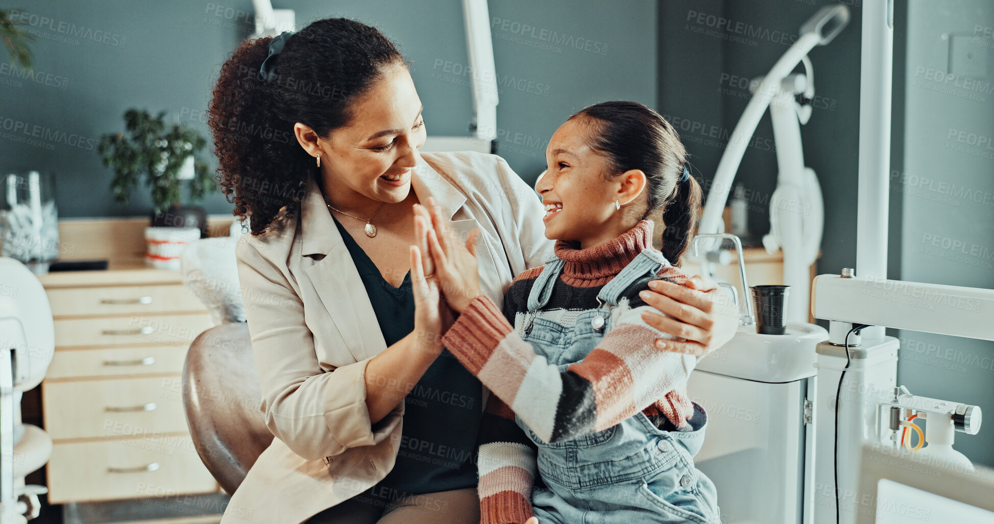 Buy stock photo Happy, mother and child in dentist office with high five, support and well done for oral procedure. Woman, daughter and celebration in clinic with smile, orthodontics or good job for dental treatment