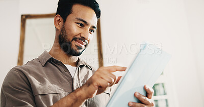 Buy stock photo Tablet, freelancer and man in home with research, story editing or happy with manuscript draft. Tech, remote work and person reading review on internet, creative chapter and author publication