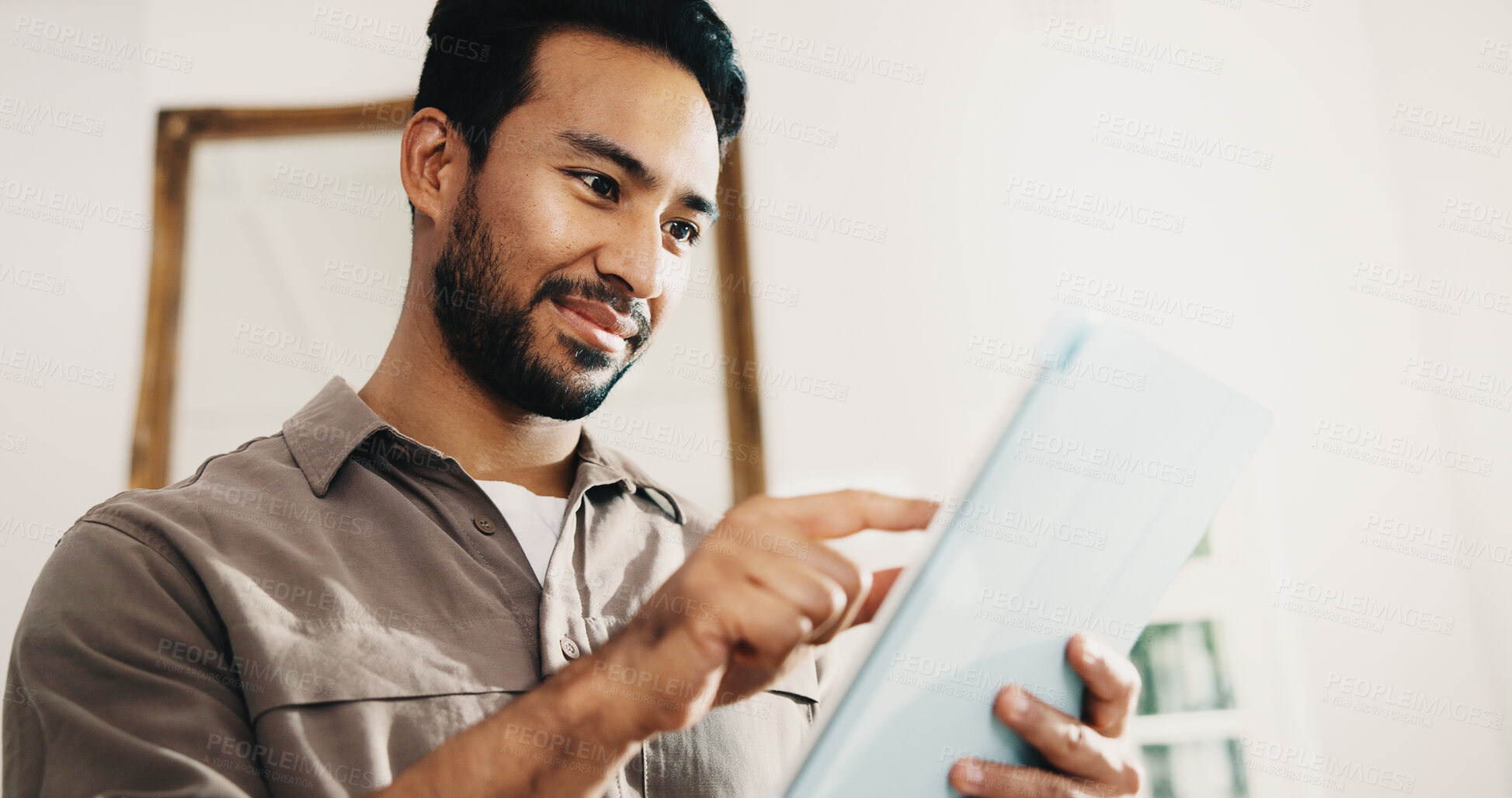 Buy stock photo Tablet, freelancer and man in home with research, story editing or happy with manuscript draft. Tech, remote work and person reading review on internet, creative chapter and author publication