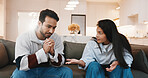 Argument, upset and couple on sofa in home for cheating, affair or divorce with toxic marriage. Fighting, disagreement and man with woman for conflict in relationship with breakup in living room.