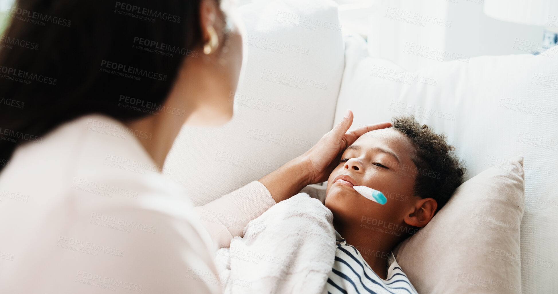 Buy stock photo Sick, mom and child in home with thermometer, childcare and health monitor with flu symptoms. Comfort, mother and son on couch with tech, parenthood and temperature check in illness assessment.