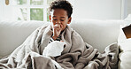 Sick, cough and child on sofa with blanket for virus, sinus infection and blowing nose for flu. Home, health and boy with napkin, respiratory disease and cold for recovery, healing and rest on couch