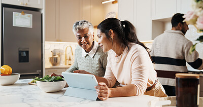 Buy stock photo Kitchen, tablet and woman with senior mother at house for preparing meal together on weekend. Cooking, digital technology and adult daughter with elderly mom for online recipe with nutrition dinner.