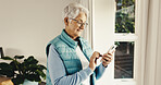Smile, old woman and reading at house with phone, social media and browsing online for bingo. Happy, senior person and scroll in home with mobile app, internet search and download games on retirement