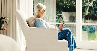 Buy stock photo Smile, old woman and relax at house with tablet, social media and browsing online for bingo. Happy, senior person and reading in lounge with digital, internet search and download games on retirement