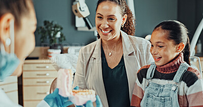 Buy stock photo Dentist, girl or mom with jaw model for consultation, cleaning or gum disease for dental help. Talk, happy kid or mother for teeth whitening, oral care education or treatment plan for mouth procedure