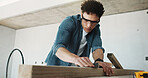 Man, carpenter and sandpaper for construction with timber, restoration and furnishing for expansion. Male person, sanding and wood at site for carpentry, smooth surface and woodworking for renovation