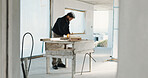Man, carpenter and writing on wood for construction, measuring and woodwork accuracy for expansion. Person, tape measure and timber at site for carpentry, measurements and information for renovation