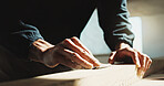 Hands, person and sandpaper with wood for carpentry, restoration and furnishing for expansion. Carpenter, sanding and timber at site for construction, smoothing surface and woodworking for renovation
