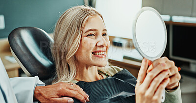 Buy stock photo Woman, smile and dentist with mirror for teeth whitening, results and oral hygiene at dental clinic. Happy, patient and healthcare at orthodontist for tooth cleaning, veneers and medical implants