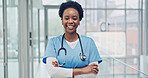 Doctor, woman and arms crossed in hospital for medical expertise, physician dedication and about us. Healthcare, black person and happy in portrait for clinical service, patient care and career pride