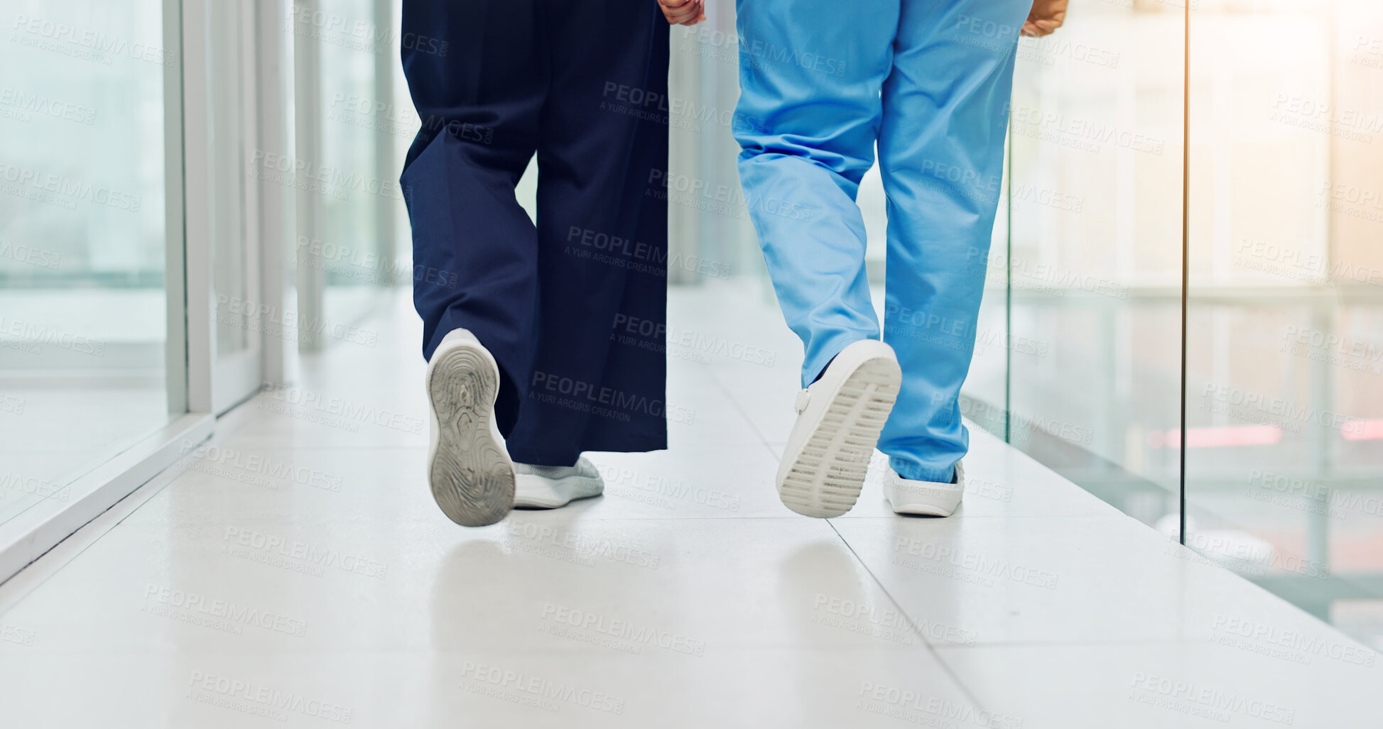 Buy stock photo Legs, team and walk in hospital hallway for medical service, staff duty and postoperative care. People, nurse feet and surgeon on the move in clinic for shift start, ward round and health treatment