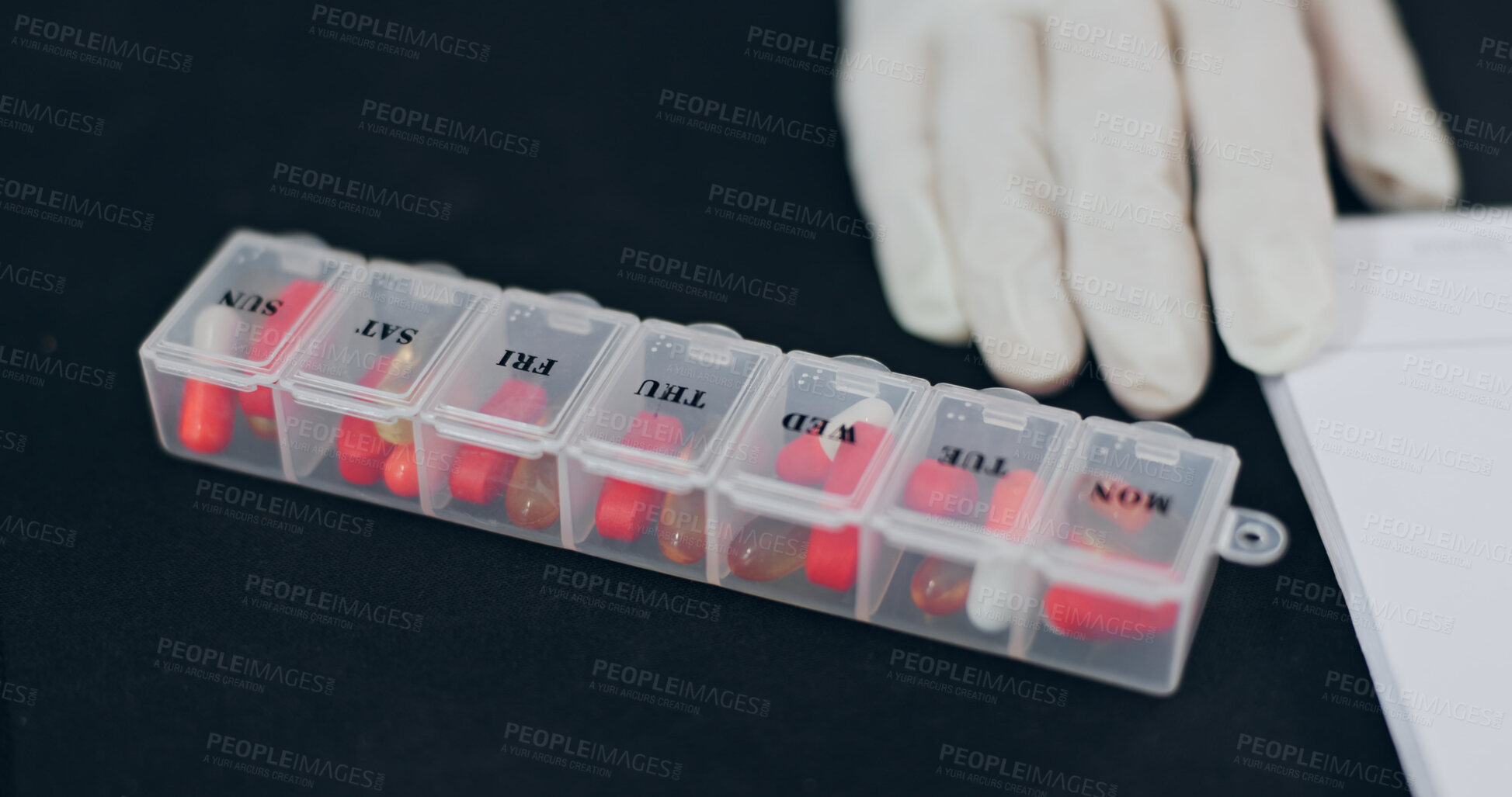 Buy stock photo Hand, doctor and medicine storage with document, daily dosage and drugs prescription for treatment. Glove, person and pills in container with paperwork, medical script and reminder for pharmaceutical