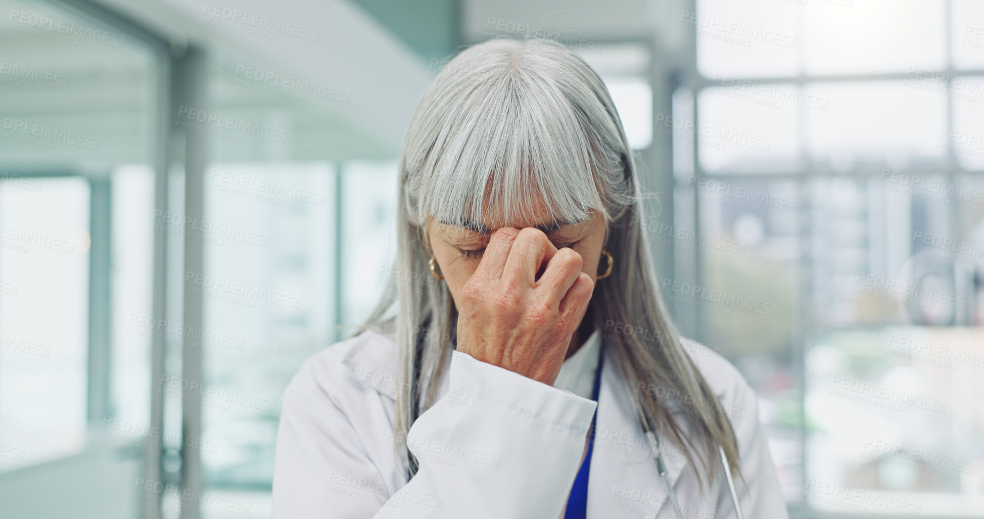 Buy stock photo Mature, woman and doctor with headache in hospital for stress, mental health or overworked pressure. Tired, female person or healthcare worker with migraine or eye strain for fatigue or burnout