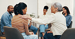 Counseling, group and women with shoulder touch, comforting and empathy in mental health center. Compassion, sad person or psychologist with support, understanding or sympathy in peer therapy session