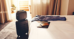 Suitcase, hotel and passport in bedroom for travel, checkin or holiday vacation in luxury resort. Empty, luggage and technology with flight document for weekend getaway, accommodation or hospitality