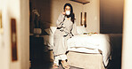Woman, relax and drink coffee on hotel bed with breakfast, weekend vacation and comfortable in robe. Mature person, peaceful morning and rest in accommodation with tea, room service food and holiday.