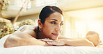 Smile, woman and relax on massage table for spa pamper, muscle therapy and hospitality reflection. Happy, mature client and thinking at resort for body care, unwind and waiting on holistic treatment