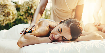 Buy stock photo Spa, woman and hot stones for back massage, stress relief and holistic treatment for healing. Hospitality, resort and person with heat for pamper, self care and relax for zen, wellness and calm
