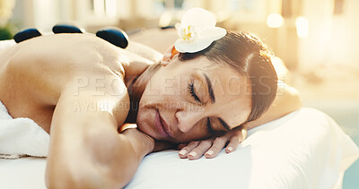 Buy stock photo Spa, relax and woman with hot stones for massage, stress relief and holistic treatment for healing. Hospitality, eyes closed and person with heat therapy for pamper, self care and calm for wellness